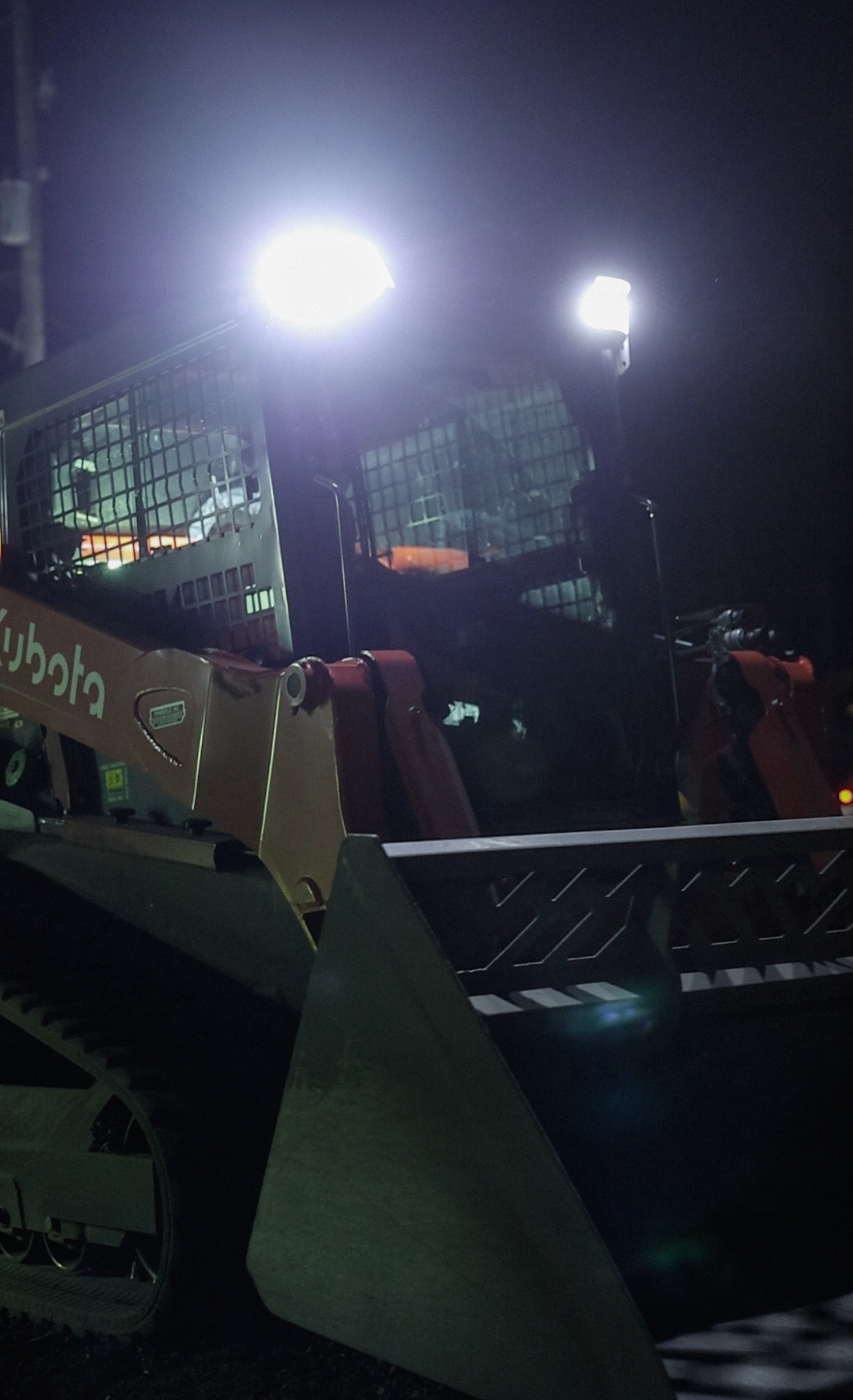 Kubota skid steer at night on job site