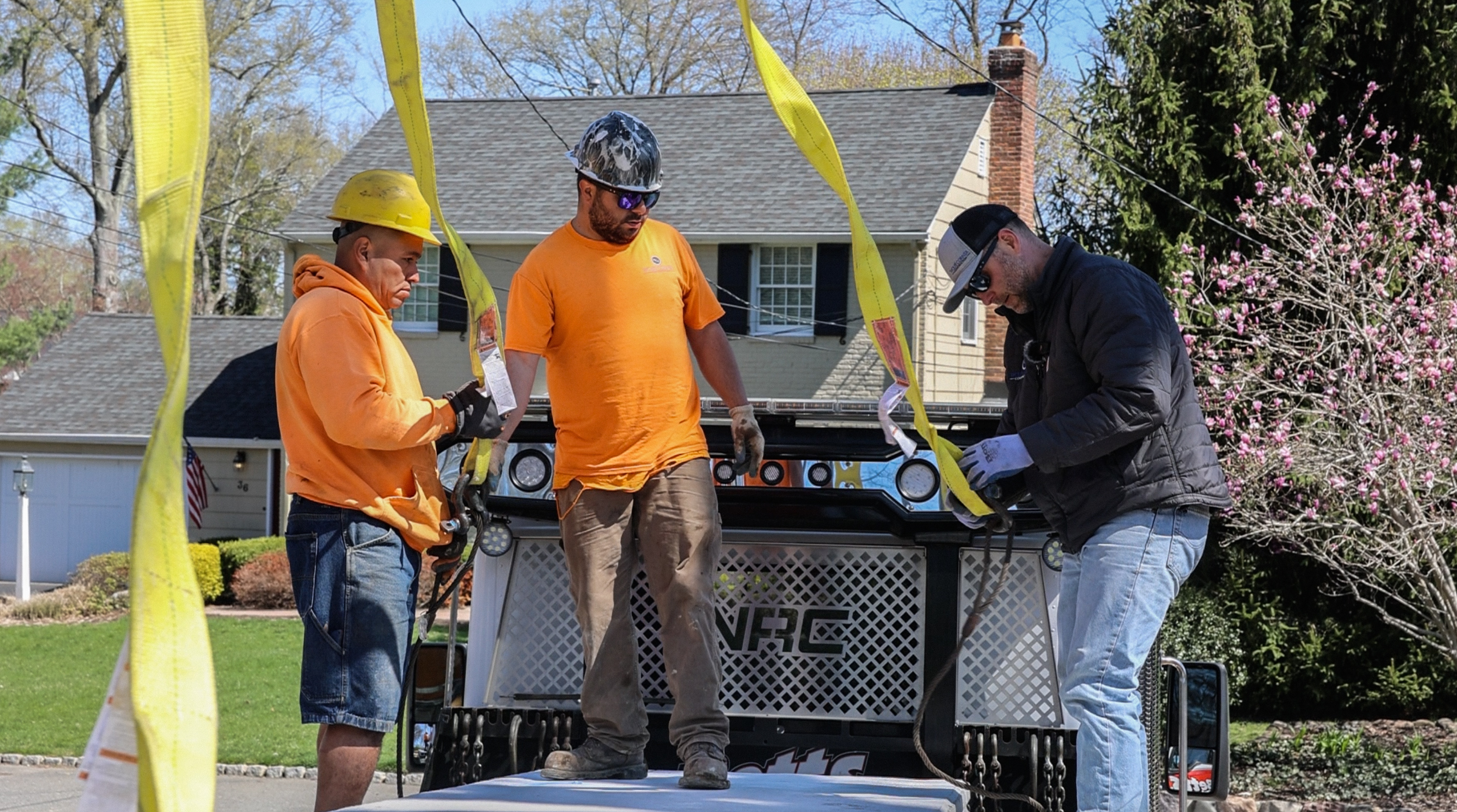 Three-man crew coordinating on job site