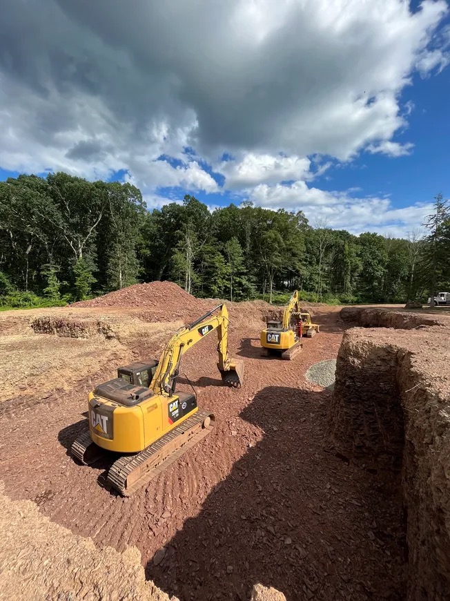 Three CAT excavators on large foundation dig