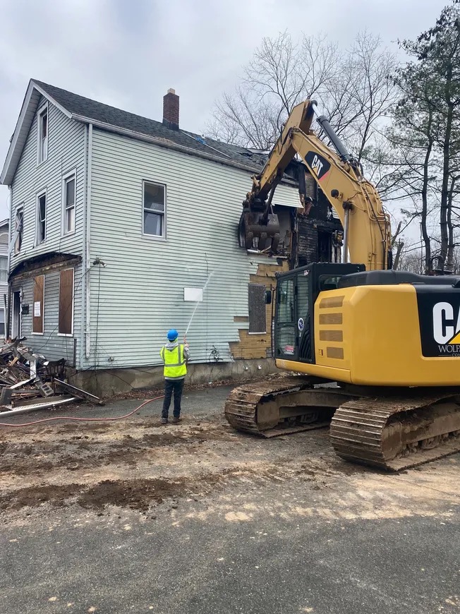 Excavator beginning residential demolition